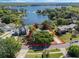 Gorgeous aerial view of a home with lake access, showcasing mature trees and beautiful landscaping at 7540 Lake Marsha Dr, Orlando, FL 32819