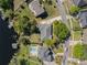 Aerial view of a luxurious home with a backyard pool and lake access with dock at 7540 Lake Marsha Dr, Orlando, FL 32819