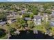 Gorgeous aerial view of a lovely lakefront property with a private dock and lush landscaping at 7540 Lake Marsha Dr, Orlando, FL 32819