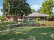 Spacious backyard with brick accents and lush landscaping, enhancing the home's curb appeal and outdoor living space at 7540 Lake Marsha Dr, Orlando, FL 32819
