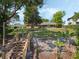 View of the backyard, featuring a private dock, lush landscaping, and the home's exterior, perfect for lakeside living at 7540 Lake Marsha Dr, Orlando, FL 32819