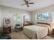 Bedroom featuring two windows for natural light, a ceiling fan, and neutral color carpet at 7540 Lake Marsha Dr, Orlando, FL 32819
