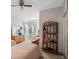 Bedroom features a ceiling fan, window nook, and shelf space for storage and decor at 7540 Lake Marsha Dr, Orlando, FL 32819