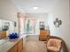 Charming bedroom with window seat, dresser, and a cozy chair bathed in natural light at 7540 Lake Marsha Dr, Orlando, FL 32819