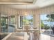 Bright dining room with lake views, chandelier, and sliding glass doors to the patio at 7540 Lake Marsha Dr, Orlando, FL 32819