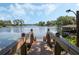 Dock overlooking a serene lake, perfect for fishing, boating, and enjoying peaceful waterfront moments at 7540 Lake Marsha Dr, Orlando, FL 32819