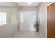 Bright entryway with decorative tiled floor, large white door, and beautiful transom windows at 7540 Lake Marsha Dr, Orlando, FL 32819