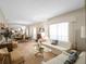 Bright living and dining rooms featuring a mirrored wall, elegant chandelier, and neutral tones at 7540 Lake Marsha Dr, Orlando, FL 32819