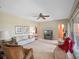 Comfortable living room with neutral tones, ceiling fan, large windows, and access to backyard at 7540 Lake Marsha Dr, Orlando, FL 32819