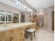 Bright bathroom features dual vanity sinks, a makeup counter, and a glass-enclosed shower at 7540 Lake Marsha Dr, Orlando, FL 32819