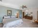 Spacious main bedroom boasts neutral paint, plush carpet, ceiling fan and ample closet space at 7540 Lake Marsha Dr, Orlando, FL 32819