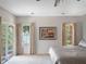 Bright main bedroom features neutral paint, plush carpeting, and an outdoor view through large windows at 7540 Lake Marsha Dr, Orlando, FL 32819