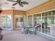 Enclosed brick patio featuring a ceiling fan, table, chairs, and sliding glass doors at 7540 Lake Marsha Dr, Orlando, FL 32819