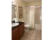 Bathroom features a shower-tub combo with tile surround and a vanity with great counter space at 8101 Resort Village Dr # 3909, Orlando, FL 32821