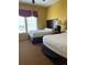 Cozy bedroom featuring two twin beds, perfect for guests or Gathering members at 8101 Resort Village Dr # 3909, Orlando, FL 32821
