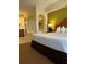 Comfortable bedroom with a king-sized bed, adjacent to a spa-like bathroom, perfect for relaxation at 8101 Resort Village Dr # 3909, Orlando, FL 32821