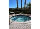 Inviting hot tub surrounded by lush greenery and brick pavers, offering a relaxing outdoor retreat at 8101 Resort Village Dr # 3909, Orlando, FL 32821