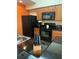 Kitchen with black appliances and granite countertops at 8101 Resort Village Dr # 3909, Orlando, FL 32821