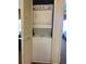 Space-saving stacked laundry unit behind louvered doors, offering convenience and practicality for everyday living at 8101 Resort Village Dr # 3909, Orlando, FL 32821