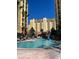 Expansive swimming pool surrounded by high-rise condos and palm trees, creating a resort-like atmosphere at 8101 Resort Village Dr # 3909, Orlando, FL 32821
