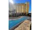 Relaxing pool area with plenty of lounge chairs and tropical landscaping near the building at 8101 Resort Village Dr # 3909, Orlando, FL 32821