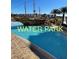 A Gathering-friendly swimming pool featuring a pirate ship water structure with buildings in the background at 8101 Resort Village Dr # 3909, Orlando, FL 32821