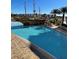 A Gathering-friendly swimming pool featuring a pirate ship water structure with buildings in the background at 8101 Resort Village Dr # 3909, Orlando, FL 32821
