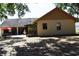 Backyard view of home with patio, fountain, and red umbrella at 859 Morning Star Dr, Lakeland, FL 33810
