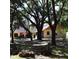 Lush backyard oasis featuring mature trees, a fire pit, and outdoor seating at 859 Morning Star Dr, Lakeland, FL 33810