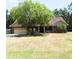Traditional-style home with a large shade tree and a well-manicured lawn at 859 Morning Star Dr, Lakeland, FL 33810