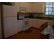 Kitchen with white appliances, oak floors, and granite countertops at 859 Morning Star Dr, Lakeland, FL 33810