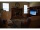 Comfortable living room with brick fireplace, plush seating, and a large television at 859 Morning Star Dr, Lakeland, FL 33810
