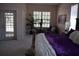 Main bedroom with a decorative headboard with balcony access and large windows at 859 Morning Star Dr, Lakeland, FL 33810
