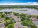 Expansive aerial view of the community, highlighting the serene lake and lush green surroundings at 903 Kersfield Cir, Lake Mary, FL 32746