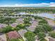 Picturesque aerial view of homes surrounded by lush landscaping and a serene lake at 903 Kersfield Cir, Lake Mary, FL 32746