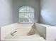 Bathroom features an oval soaking tub with jets and large window, offering natural light at 903 Kersfield Cir, Lake Mary, FL 32746