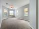 Spacious carpeted bedroom with neutral paint color, ceiling fan, and natural light from three windows at 903 Kersfield Cir, Lake Mary, FL 32746