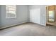 Carpeted bedroom features natural light from a window, closet with bi-fold doors, and neutral walls at 903 Kersfield Cir, Lake Mary, FL 32746