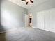 Carpeted bedroom with view to hall, featuring a closet with bi-fold doors and neutral walls at 903 Kersfield Cir, Lake Mary, FL 32746