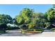 Community entrance adorned with colorful flowers and lush trees providing a warm welcome at 903 Kersfield Cir, Lake Mary, FL 32746