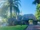 Community entrance featuring a gatehouse with manicured landscaping and mature palm trees providing a sense of arrival at 903 Kersfield Cir, Lake Mary, FL 32746