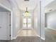 Inviting entryway with tiled flooring, glass paneled doors, and an arched doorway at 903 Kersfield Cir, Lake Mary, FL 32746