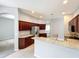 Spacious kitchen features granite countertops, stainless steel appliances, and cherry-toned cabinetry at 903 Kersfield Cir, Lake Mary, FL 32746