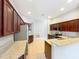 Well-equipped kitchen with stainless steel appliances, ample counter space, and cherry-toned cabinets at 903 Kersfield Cir, Lake Mary, FL 32746