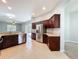 Open kitchen with stainless steel appliances, dark wood cabinetry, and granite countertops at 903 Kersfield Cir, Lake Mary, FL 32746