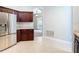 Kitchen featuring stainless steel appliances, granite countertops, and dark wood cabinets at 903 Kersfield Cir, Lake Mary, FL 32746