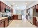 Modern kitchen featuring stainless steel appliances, granite countertops, and dark wood cabinets, offering both style and functionality at 903 Kersfield Cir, Lake Mary, FL 32746