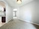 Open living space with neutral tones, carpet, and an arched doorway to the kitchen at 903 Kersfield Cir, Lake Mary, FL 32746