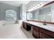 Spacious main bathroom with a double vanity, soaking tub, and granite countertops, designed for relaxation and convenience at 903 Kersfield Cir, Lake Mary, FL 32746