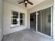 Covered patio with ceiling fan and sliding glass doors, offering a relaxing outdoor space at 903 Kersfield Cir, Lake Mary, FL 32746
